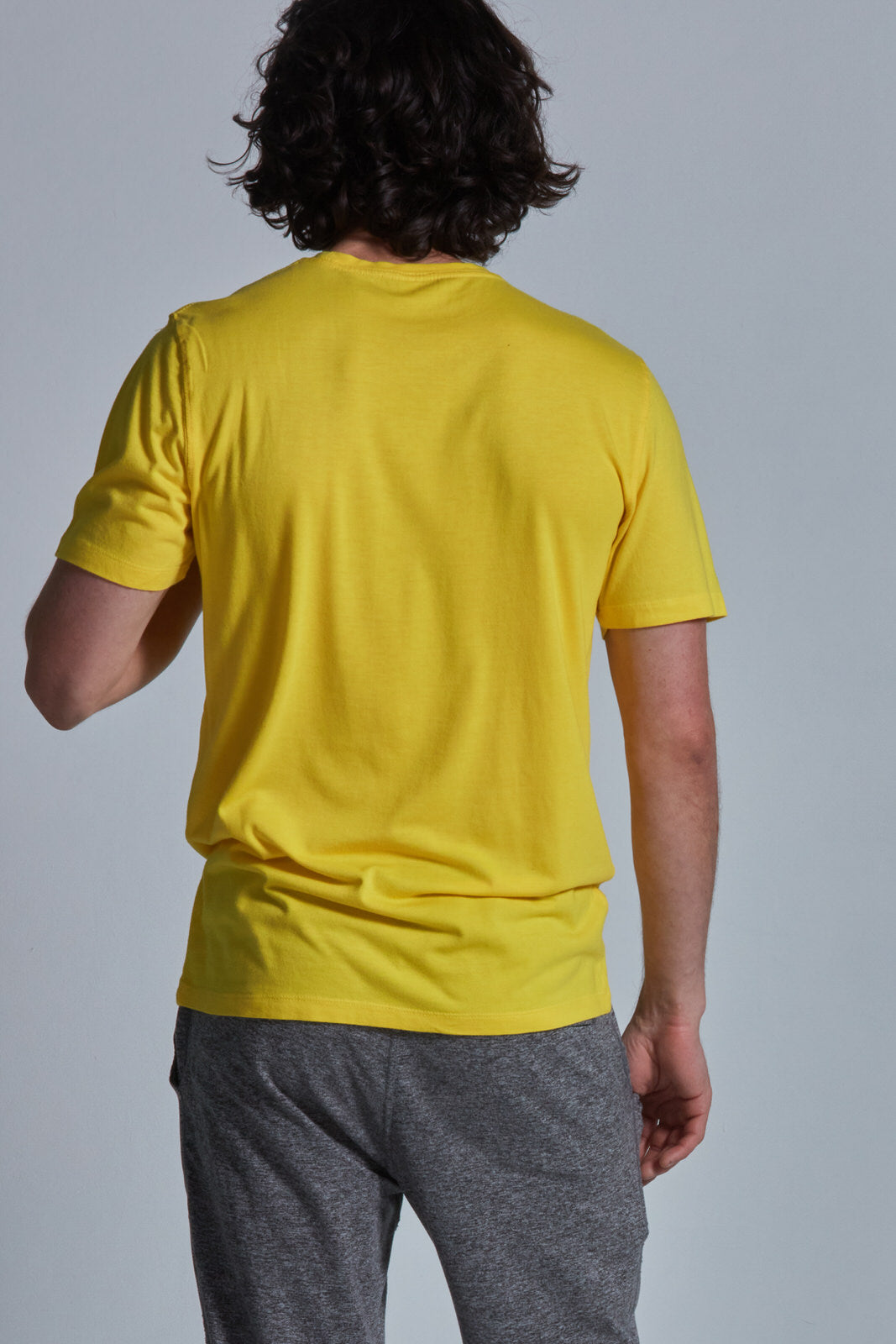 ONNO bamboo t-shirt in Bright Yellow Unpatched, Nic is 5'11" and wearing size M.