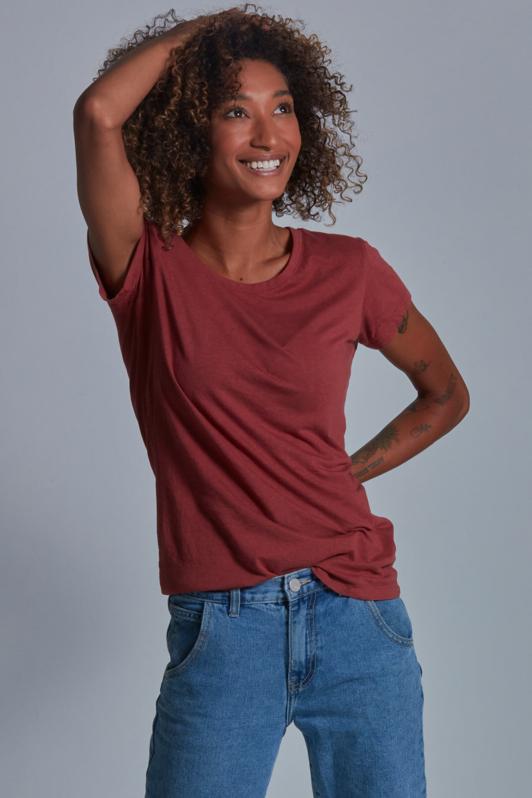 ONNO bamboo t-shirt in Brick Unpatched, Sage is 5'7" and wearing size XS.