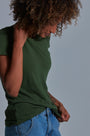 ONNO bamboo t-shirt in Moss Green Unpatched, Sage is 5'7" and wearing size XS.