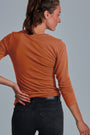 ONNO long sleeve bamboo t-shirt in Rust, Christina is 5'9" and wearing size S.