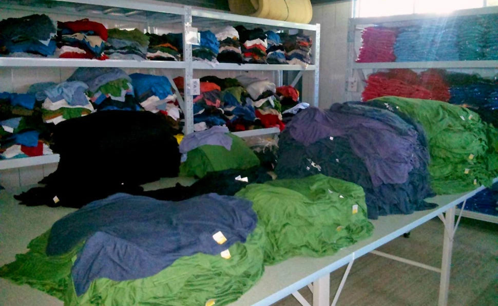 Piles of t-shirts at the ONNO t-shirt factory in China