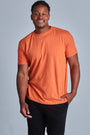 ONNO hemp t-shirt in Orange Unpatched, Golden is 6'0" and wearing size L.