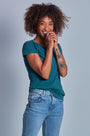 ONNO hemp t-shirt in Teal Unpatched, Sage is 5'7" and wearing size XS.