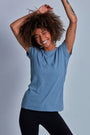 ONNO hemp t-shirt in Steel Blue Unpatched, Sage is 5'7" and wearing size XS.