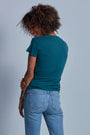 ONNO hemp t-shirt in Teal, Sage is 5'7" and wearing size XS.