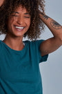 ONNO hemp t-shirt in Teal, Sage is 5'7" and wearing size XS.