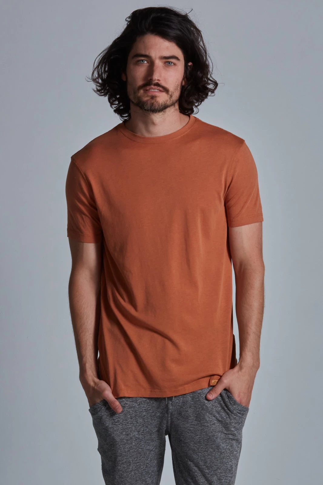 ONNO lyocell bamboo t-shirt in Rust, Nic is 5'11" and wearing size M.