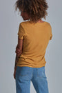 ONNO beechwood t-shirt in Mustard, Sage is 5'7" and wearing size XS.