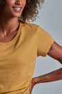 ONNO beechwood t-shirt in Mustard, Sage is 5'7" and wearing size XS.