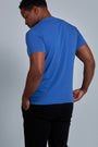 ONNO organic cotton t-shirt in Blue Ink Unpatched, Golden is 6'0" and wearing size L.