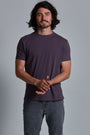 ONNO organic cotton t-shirt in Dirty Purple Unpatched, Nic is 5'11" and wearing size M.