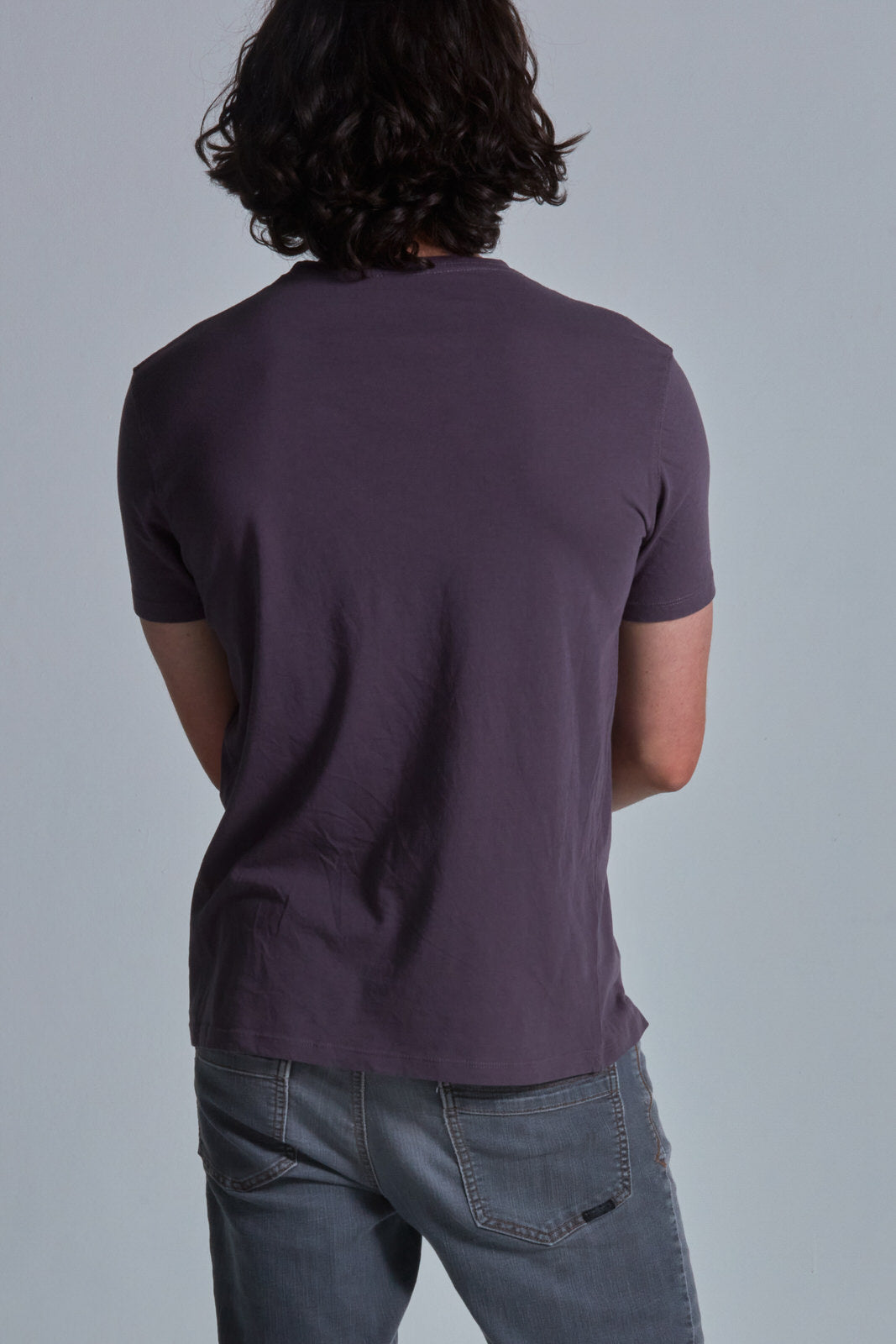 ONNO organic cotton t-shirt in Dirty Purple Unpatched, Nic is 5'11" and wearing size M.