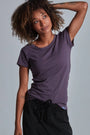 ONNO organic cotton t-shirt in Dirty Purple, Sage is 5'7" and wearing size XS.